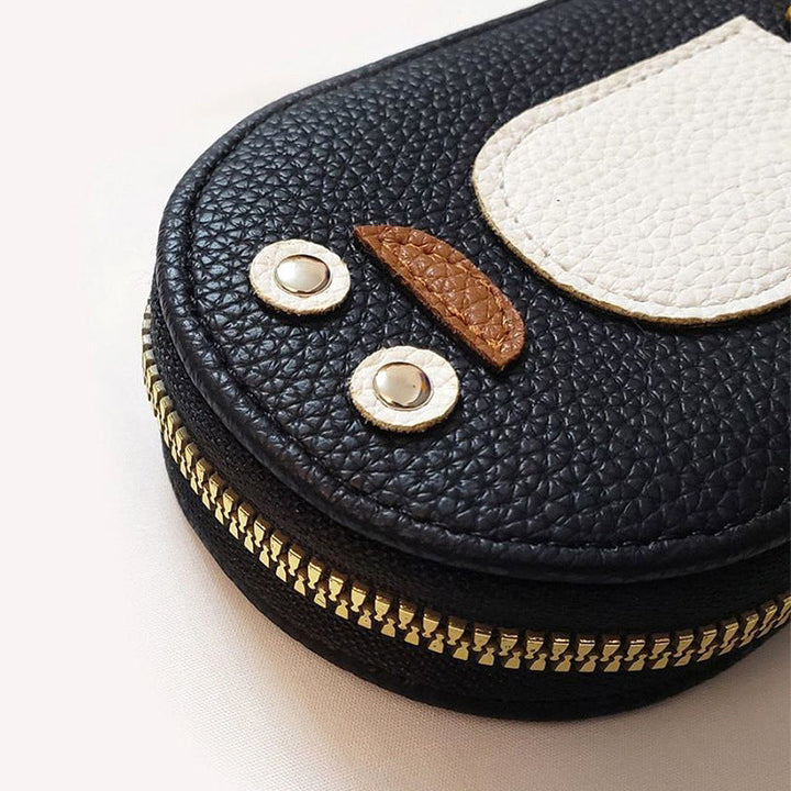 Close-up of a women's PU leather wallet with a charming penguin illustration.