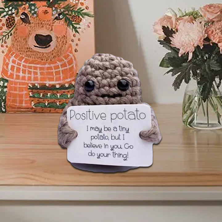 Positive potato knitted doll with googly eyes, a quirky and funny encouragement gift for office or home.