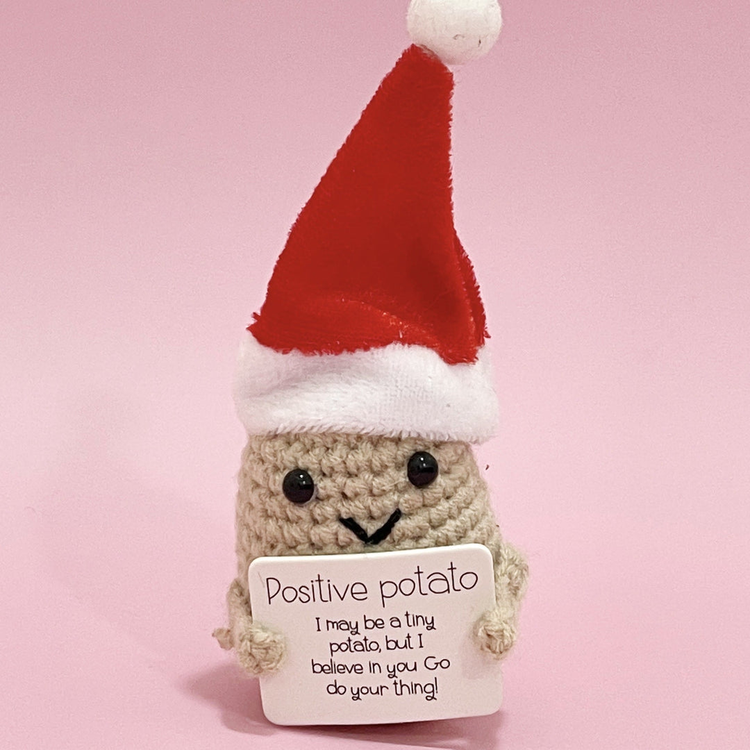 Close-up of a positive potato knitted doll, showcasing its detailed craft, an inspiring desk decor.