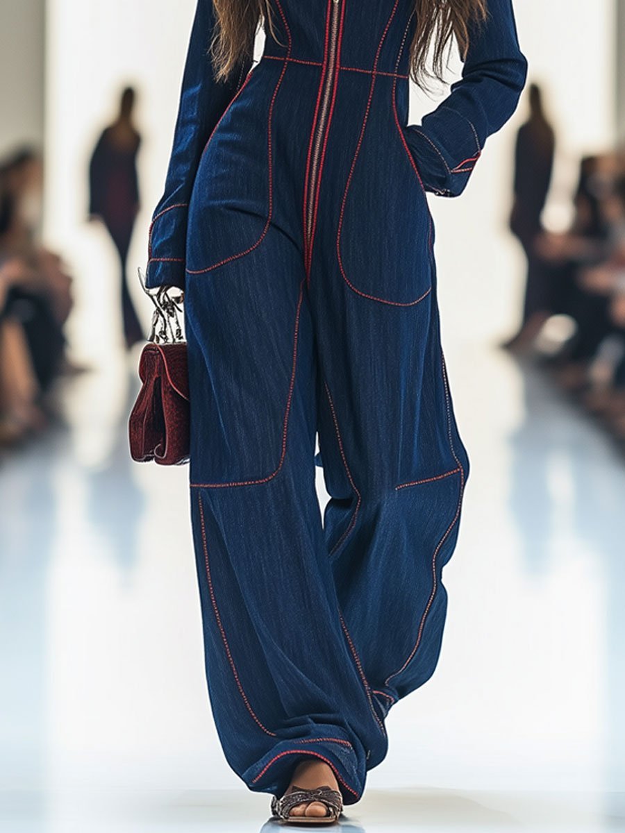 Versatile dark blue wide leg jumpsuit for women. Features a flattering cut, long sleeves, and a front zip.