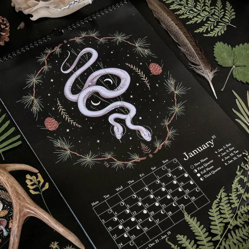 Close-up of Dark Forest Lunar Calendar showing intricate witchy illustration and moon cycle details
