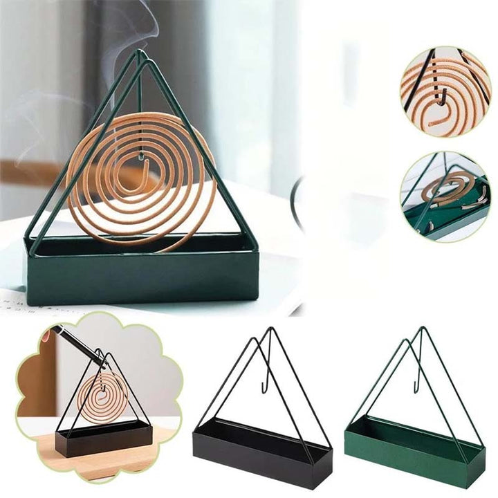 Decorative iron mosquito coil holder with intricate cutouts, safe and stylish for outdoor pest control.