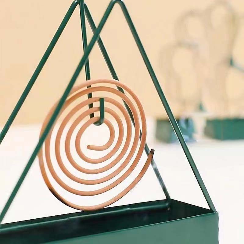 Artistic iron coil holder for mosquito repellent, protecting your outdoor space from insects in style.