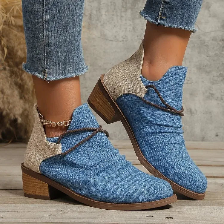 Pair of women's denim blue woven textile boots with block heels, casual fashion