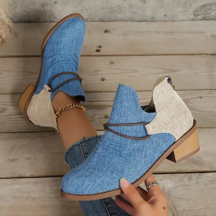 Detail of the woven texture on women's denim blue textile boots with block heel