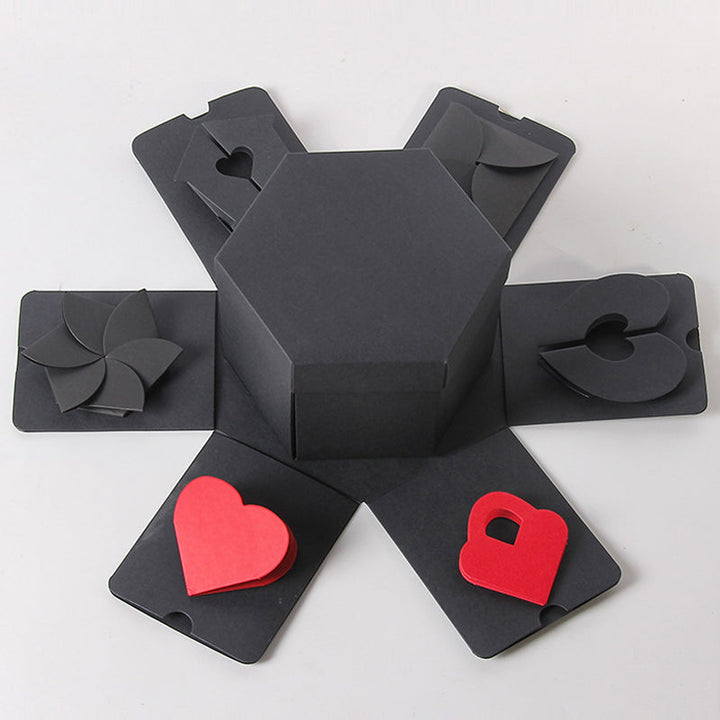 Girl assembling a DIY explosion box, gluing photos and embellishments for a personalized memory box or scrapbook