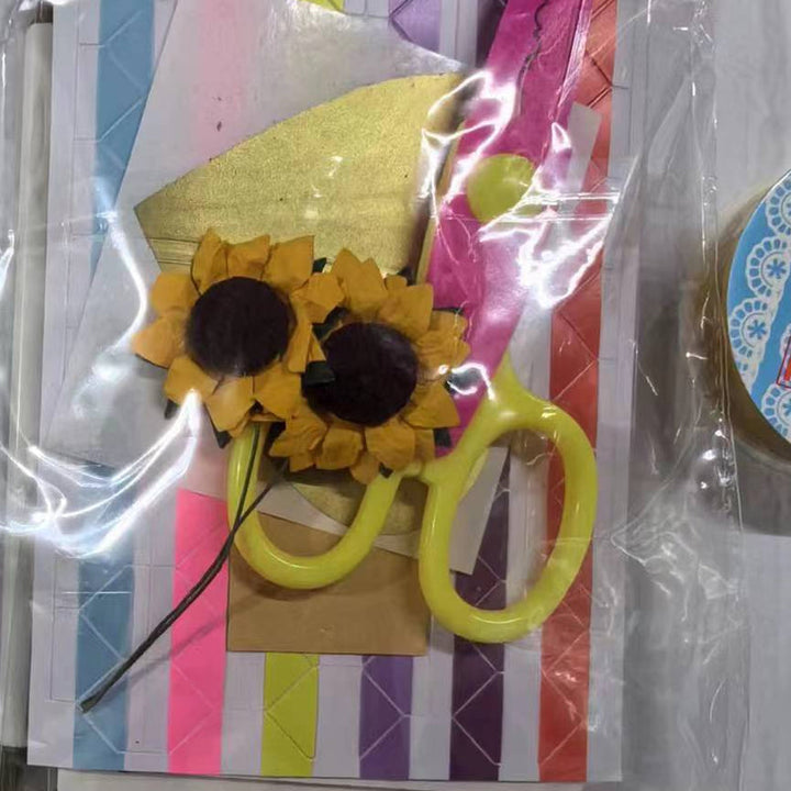 Variety of decorative papers and accessories used to create a DIY explosion gift box, emphasizing its creative aspect