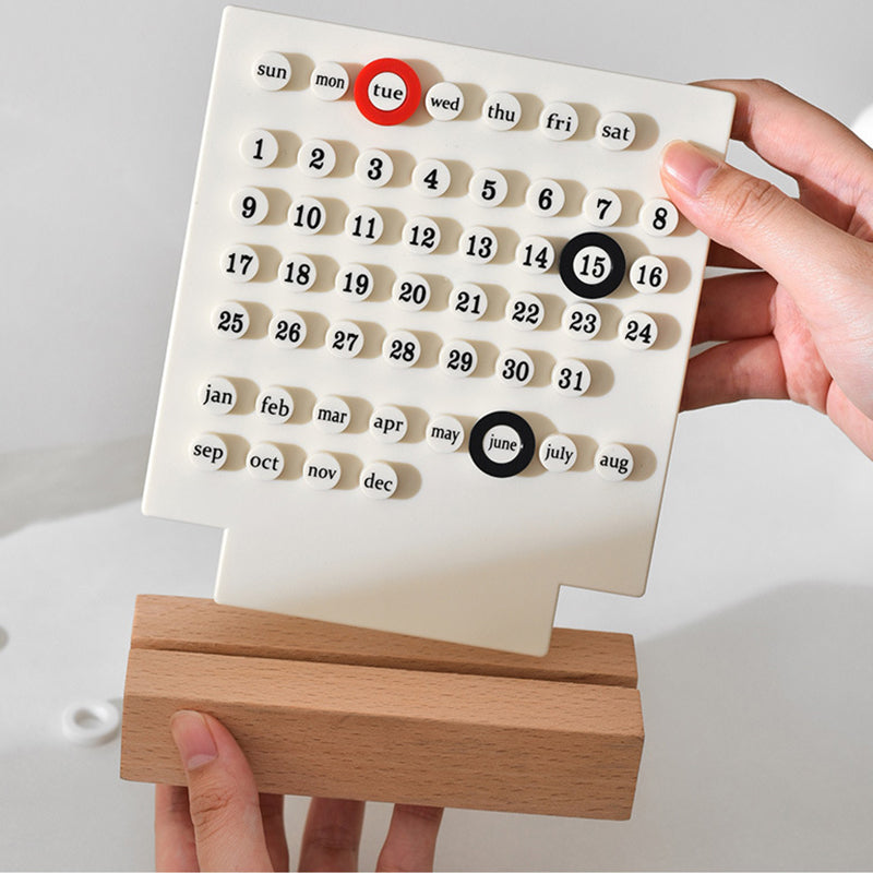 Completed perpetual desk calendar made from a DIY kit, showing month and day blocks