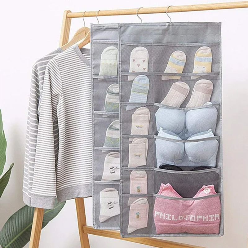 Dual-sided hanging closet organizer with mesh pockets, optimizing wardrobe storage space.