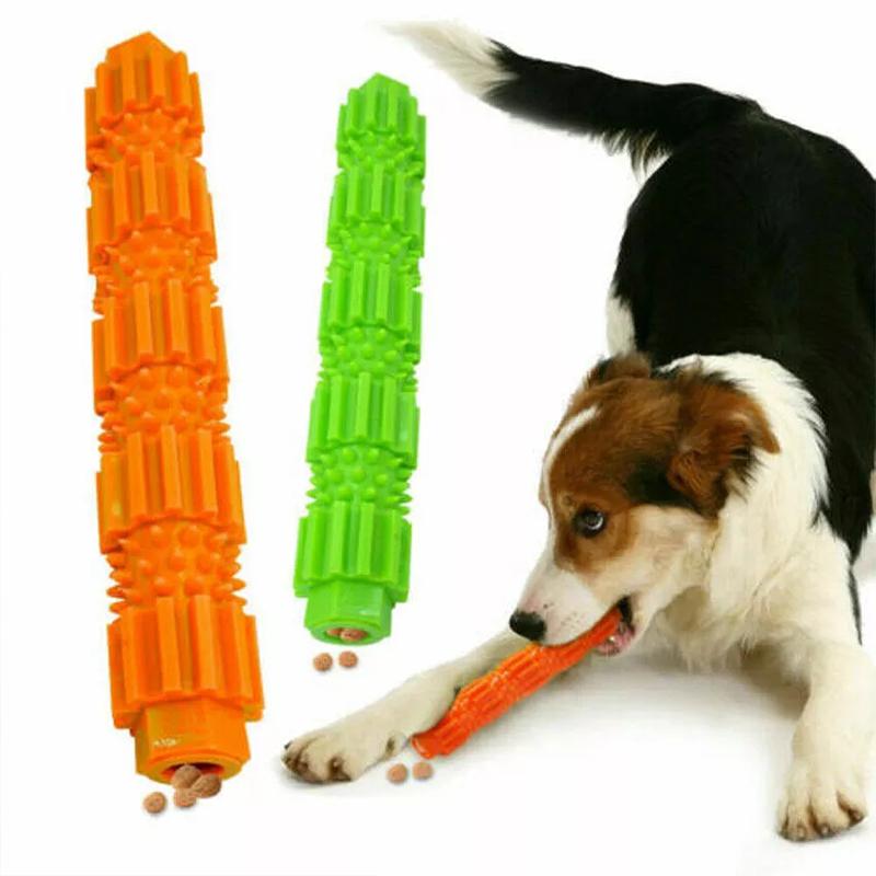 Dog playing happily with a red dental chew toy, demonstrating its durability and interactive nature