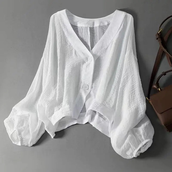 Effortless white summer blouse for women, featuring a relaxed fit, lightweight fabric, and stylish button detail.