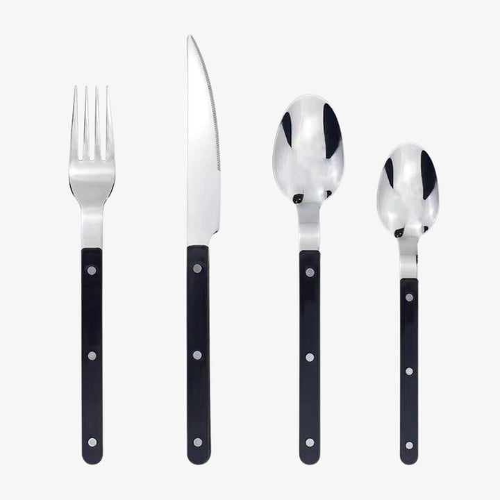Elegant 24-piece stainless steel dining cutlery set with intricate engraved design for a sophisticated table setting.
