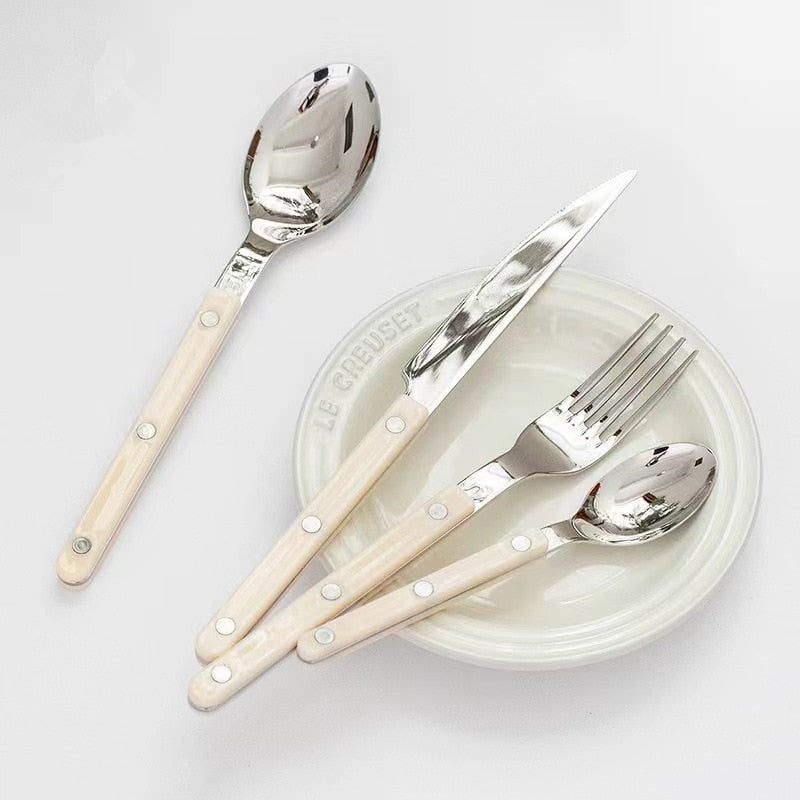 Luxury 24-piece engraved stainless steel dining set, enhancing your dinnerware with elegance.