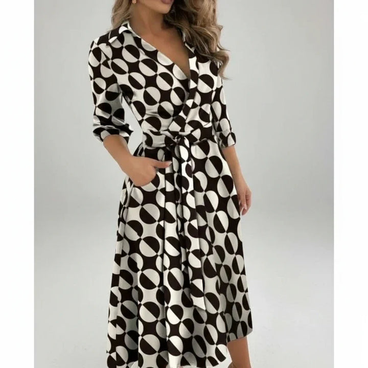 Elegant women's belted A-line midi dress. Features a V-neck & 3/4 sleeves.