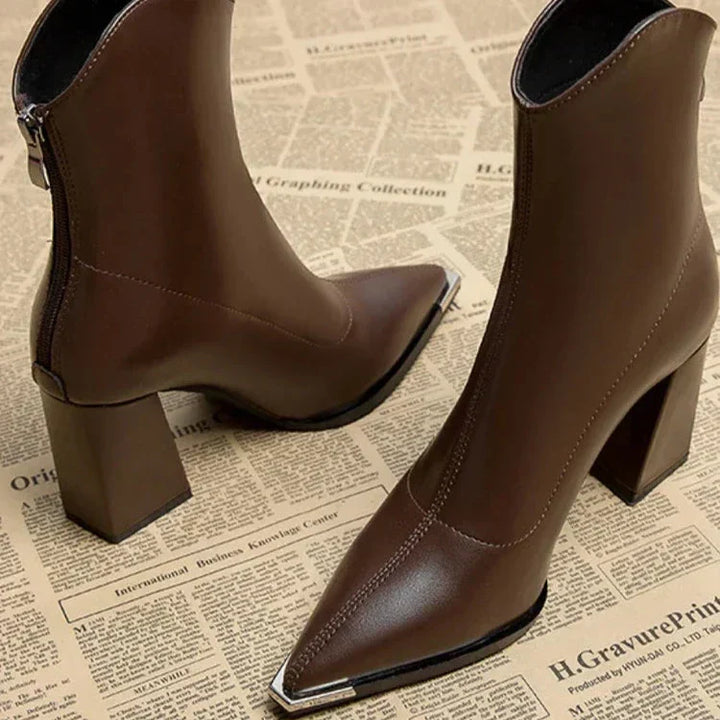Versatile black ankle boots with a pointed toe and block heel, a must-have for women's footwear.