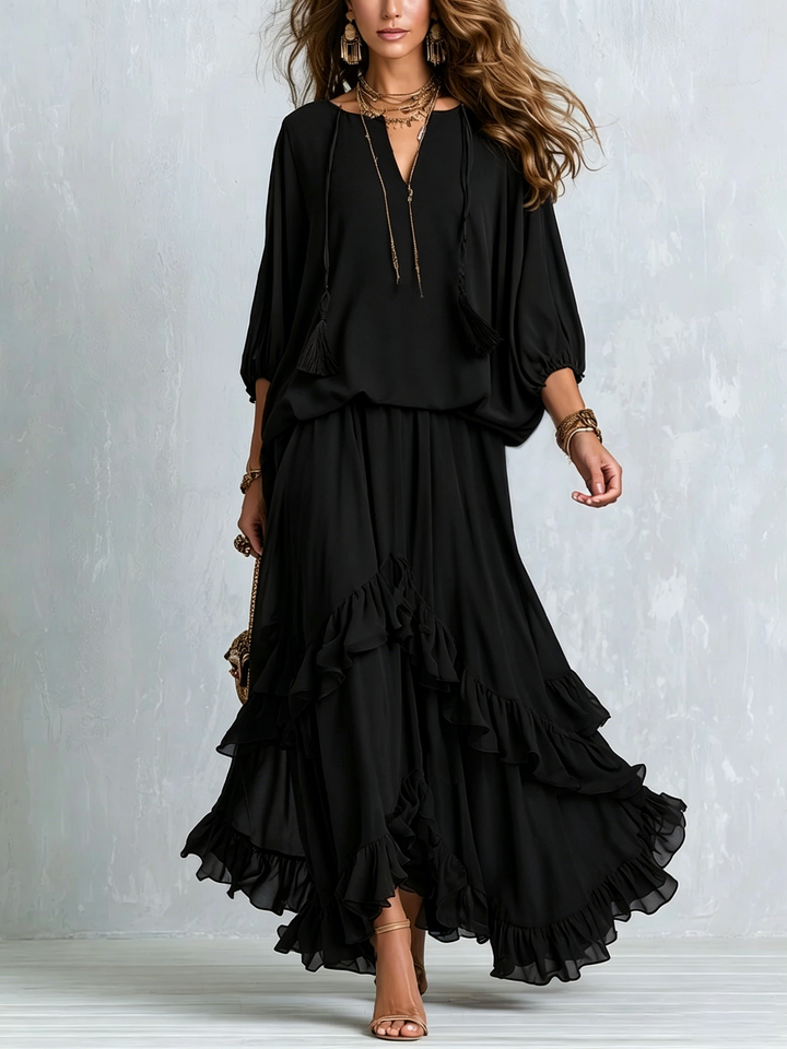 Elegant black boho maxi skirt and V-neck top set with lantern sleeves and ruffled tiers for women. Perfect summer evening wear.