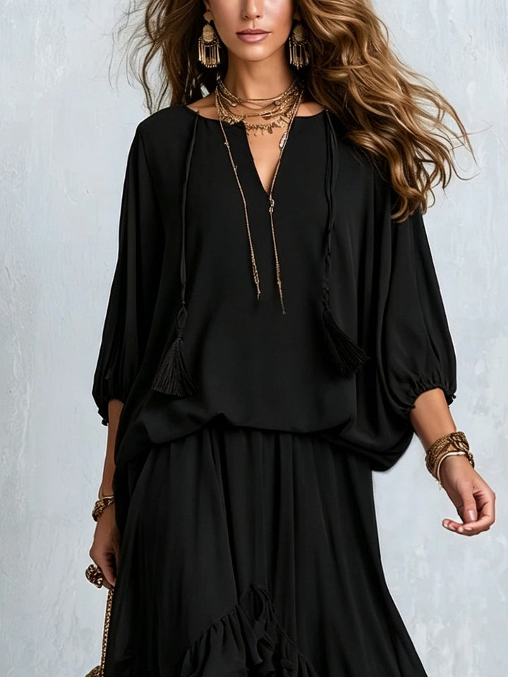 Chic black elegant women's matching set: V-neck lantern sleeve top & ruffled tiered boho maxi skirt for occasion wear.
