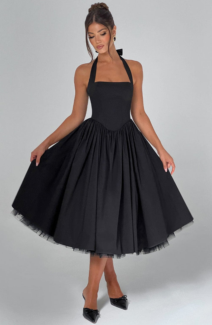 Halter neck midi dress in white, folded neatly, showcasing its elegant fabric and design
