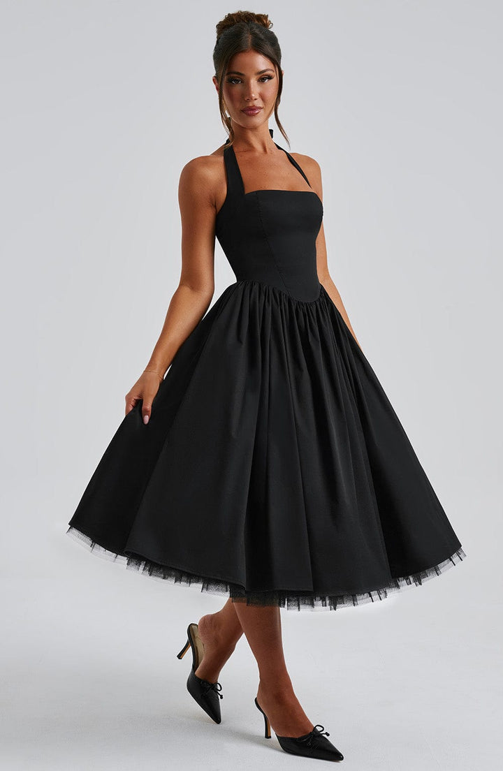 Close-up of the hemline of the women's halter neck midi dress, featuring a sophisticated cut