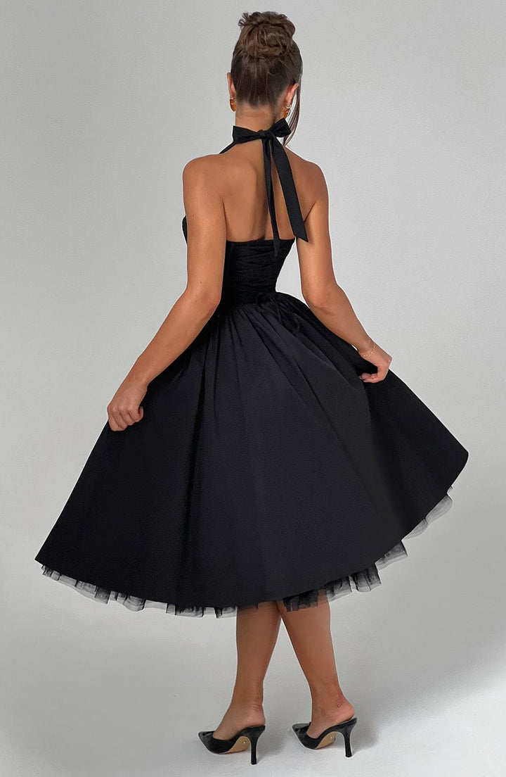 Two women showcasing the versatile black and white halter neck midi dresses for formal events