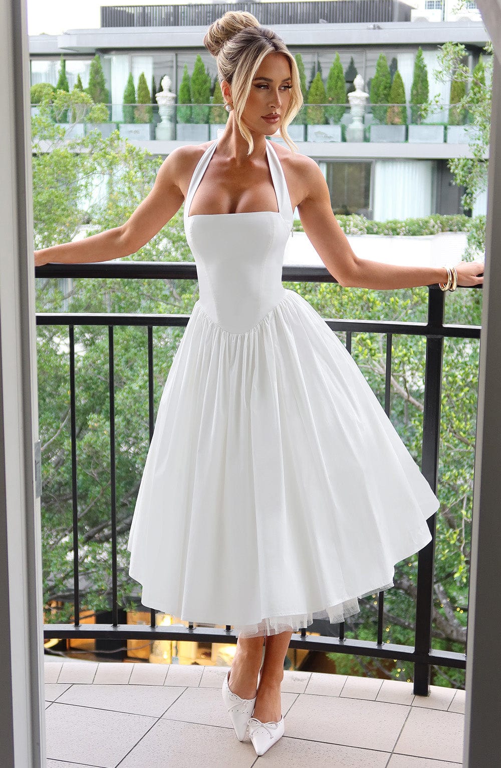 Stylish white halter neck midi dress for women, an elegant choice for formal events and occasions