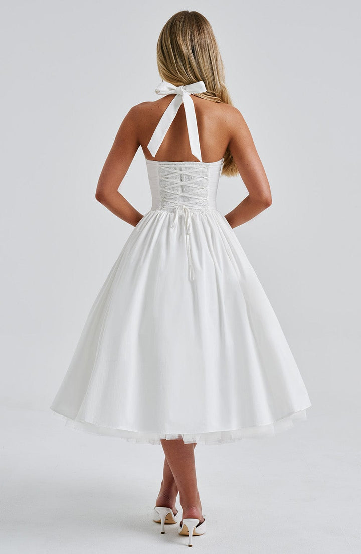 Side profile of the women's black halter neck midi dress, highlighting its elegant fit and style