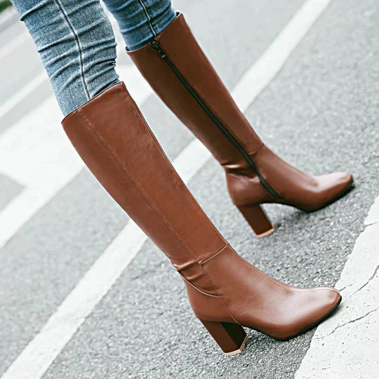 Stylish women's knee-high boots in a rich black, featuring a sophisticated heeled design.