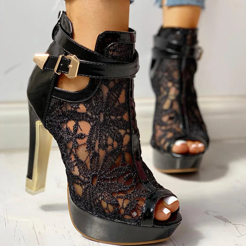 Detailed shot of the heel and platform on women's elegant black lace high heels, emphasizing quality.