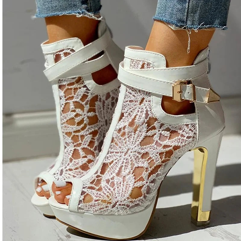 Side view of a women's formal black platform high heel with ornate lace pattern and sturdy platform.
