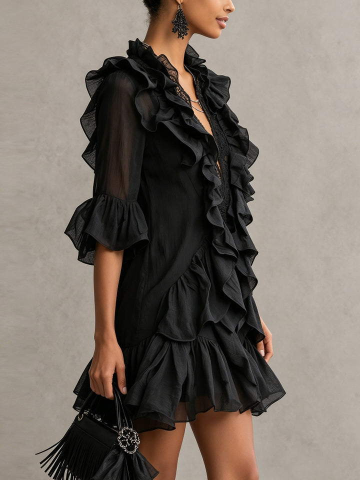 Women's elegant black mini cocktail dress featuring ruffles, V-neck, & sheer sleeves. Ideal for date night.
