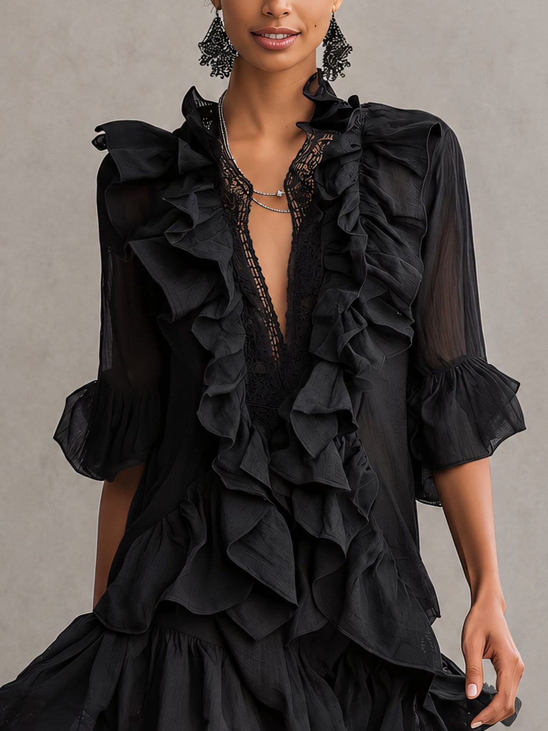 Stylish black mini dress for women featuring tiered ruffles, a flattering V-neck, and chic sheer sleeves.