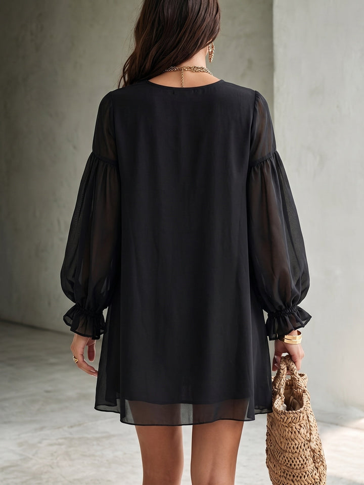 Chic black V-neck mini dress with flowy balloon sleeves. Women's elegant party and evening dress for special occasions.