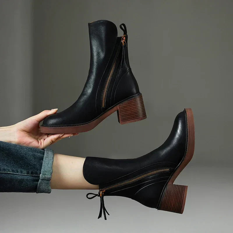 Elegant black women's block heel ankle boots with a stylish side zipper, perfect for fall fashion.