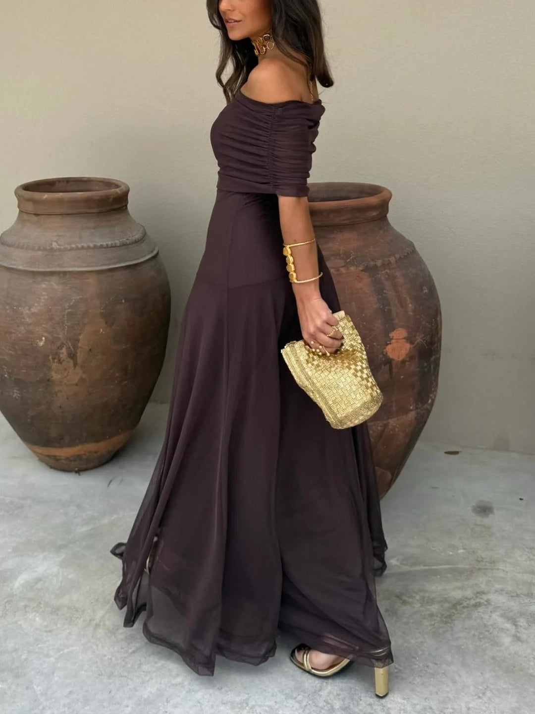 Women's elegant brown off-shoulder formal maxi dress with sheer overlay, ideal for special occasions.
