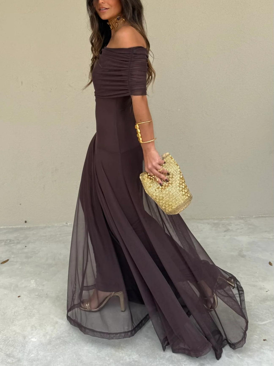 Stunning off-shoulder brown maxi evening gown featuring a delicate sheer overlay, perfect formal attire.