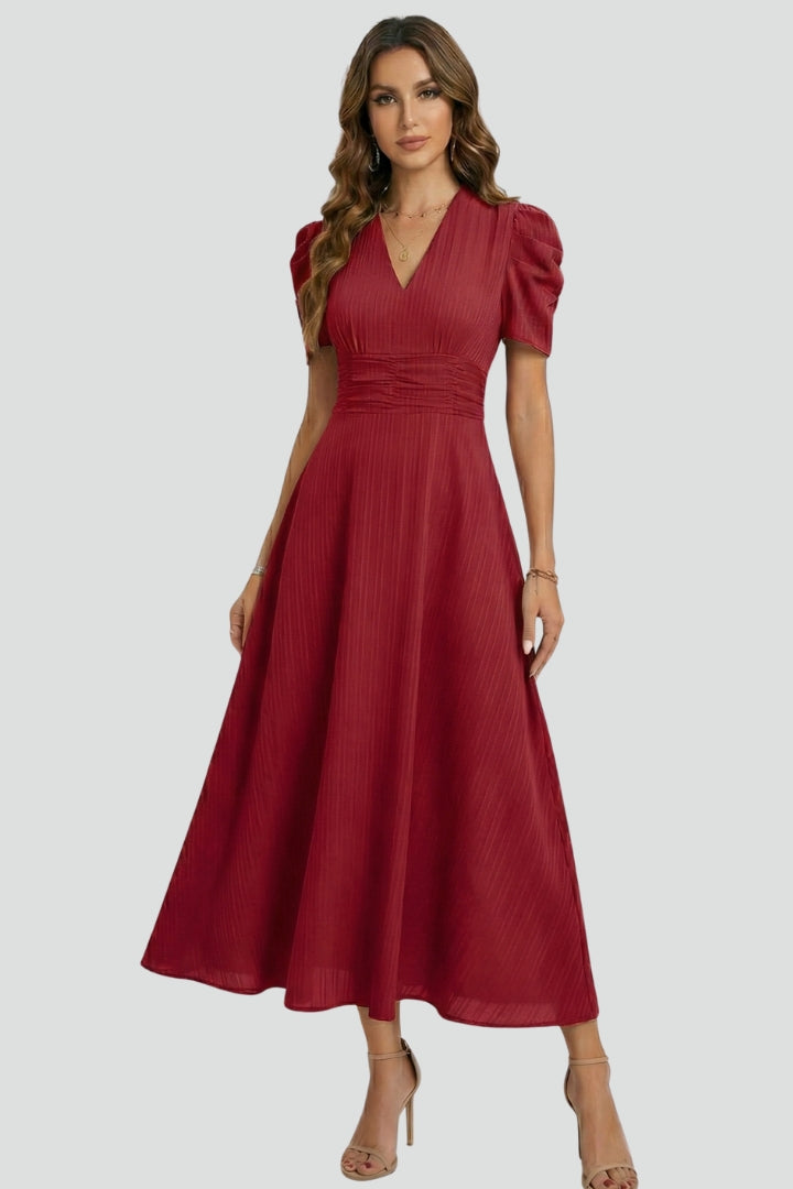 Flattering brown midi dress with V-neckline, short sleeves, ruched waist detail, and a graceful flared skirt.