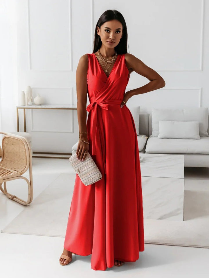 Navy blue faux wrap maxi dress with V-neckline & flowy skirt, a chic wedding guest outfit.