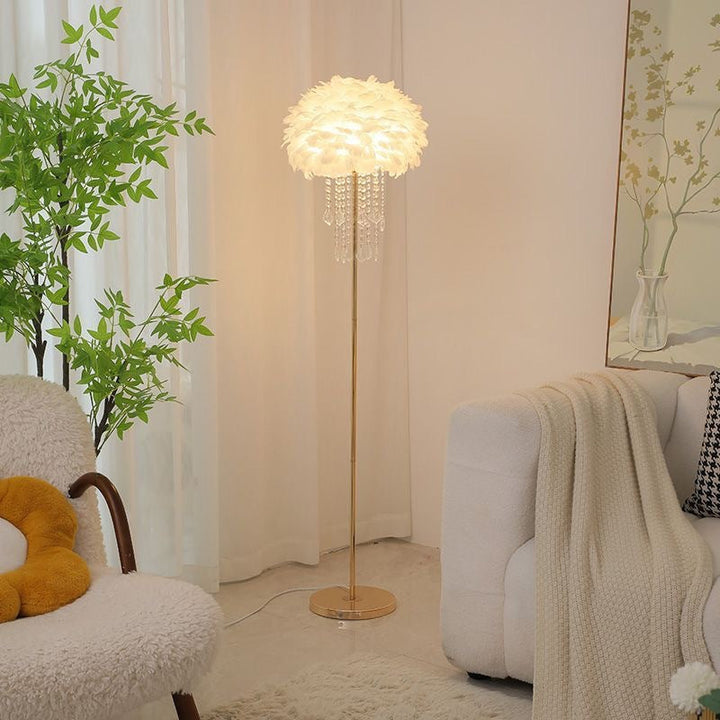 Modern feather and crystal floor lamp providing elegant ambient light for bedrooms.