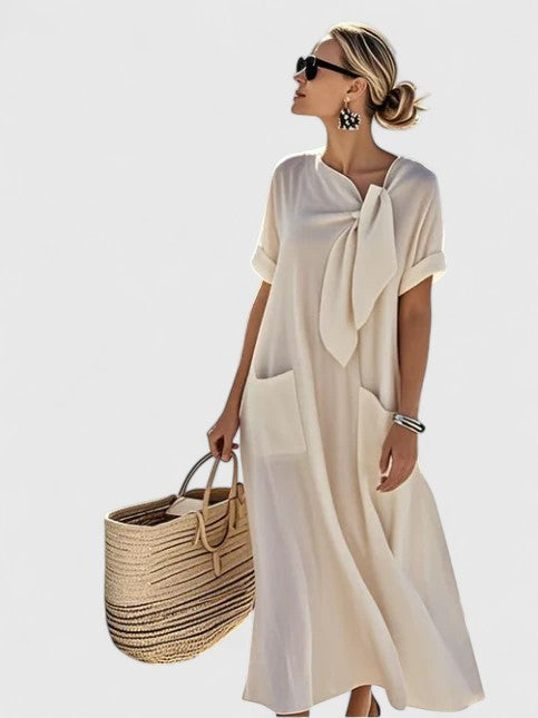 Chic women's flowing summer dress with practical pockets, ideal for versatile wear.