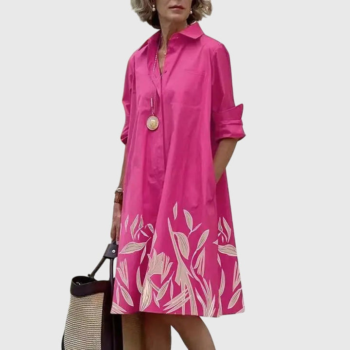 Chic neckline detail on an elegant flowy women's dress. Comfortable, stylish summer dress with practical pockets.