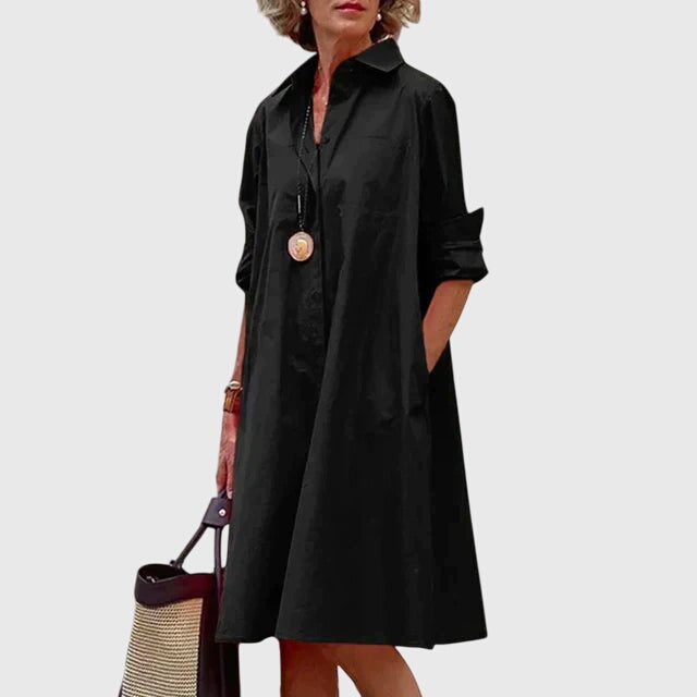 Woman confidently wearing an elegant flowy dress with pockets. Stylish, comfortable & versatile summer wear.
