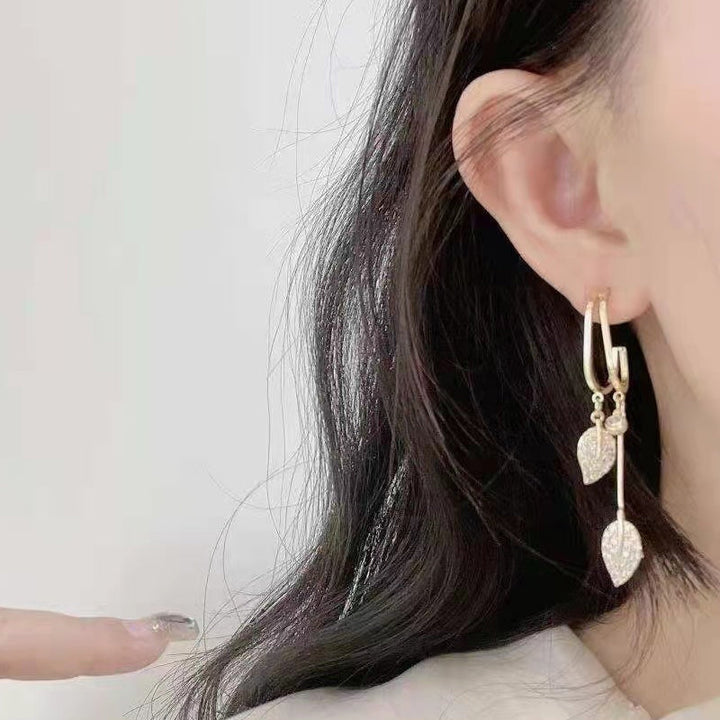Exquisite gold sea leaf dangle earrings, an elegant gift for women who appreciate unique jewelry