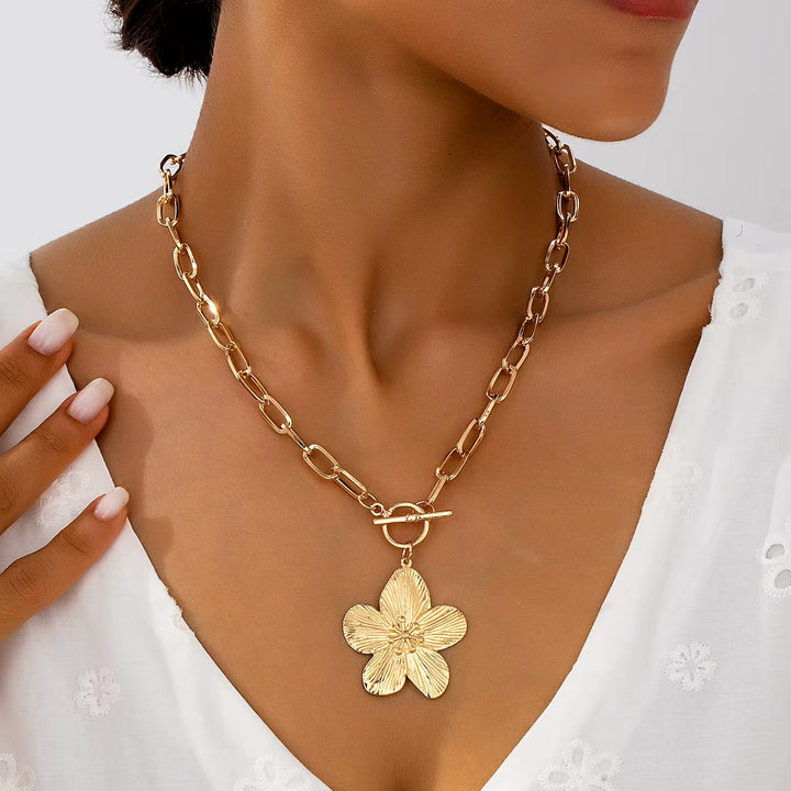 Elegant gold-toned textured wisteria flower pendant necklace, perfect women's floral charm jewelry with vintage style.