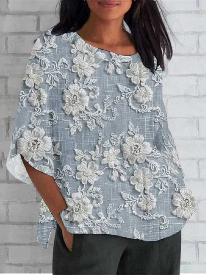 Blue women's bohemian style 3/4 sleeve blouse with intricate floral embroidery, ideal for elegant everyday wear.
