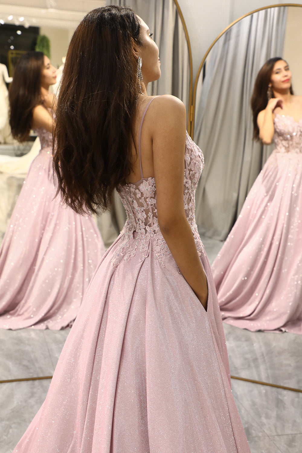 Women's formal light pink maxi dress with intricate embellishments, ideal for an elegant wedding guest look.