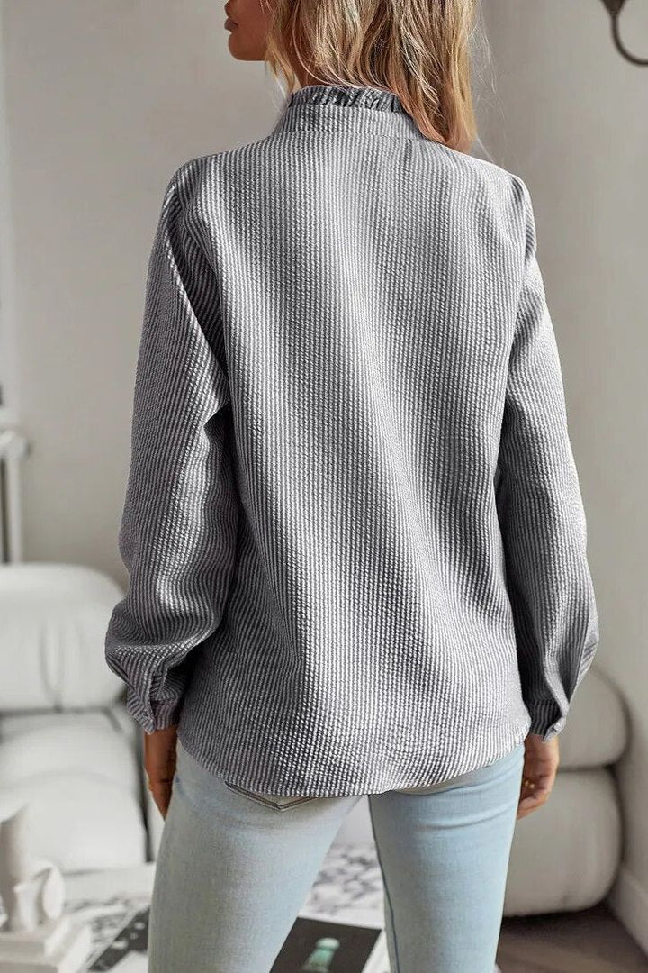 Classic black long sleeve blouse for women, an elegant and versatile top for office and casual chic.