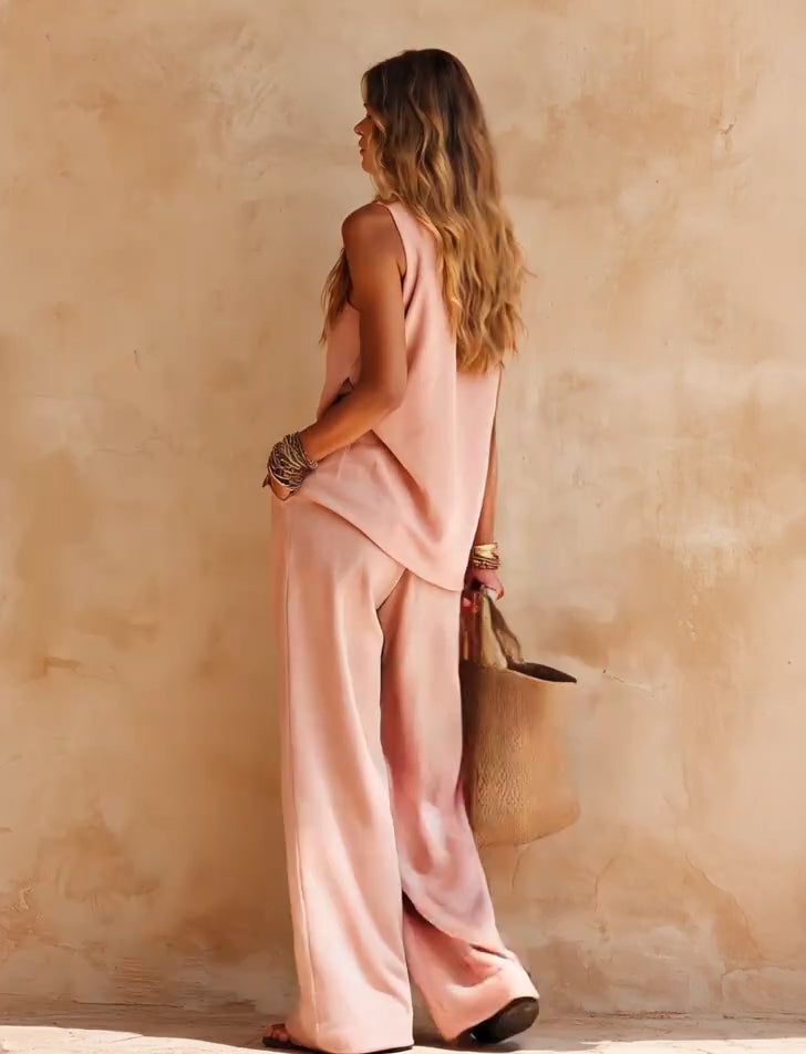 Chic women's one-shoulder jumpsuit with draped wide legs. Ideal flowing party outfit or vacation wear.