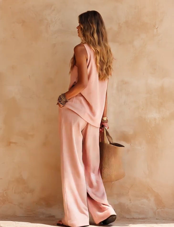 Chic women's one-shoulder jumpsuit with draped wide legs. Ideal flowing party outfit or vacation wear.
