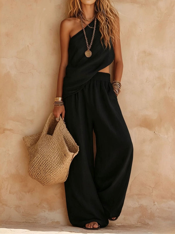 Sophisticated women's jumpsuit featuring one shoulder and a draped wide leg. Perfect for chic occasion wear.