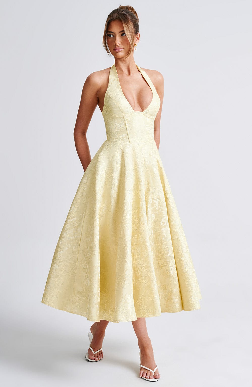 Pink formal midi dress with an elegant halter neck, suitable for cocktail parties.